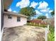 Backyard with concrete patio, partial wood fence, and surrounding landscaping at 10739 Se 44Th Ter, Belleview, FL 34420