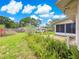 Well-maintained backyard with lush ferns, green grass, and partial wood privacy fence at 10739 Se 44Th Ter, Belleview, FL 34420