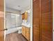 Bathroom with white vanity, mirrored cabinet, and shower-tub with sliding glass doors at 10739 Se 44Th Ter, Belleview, FL 34420