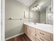 Well-lit bathroom features a light wood vanity, white countertop, and large mirror at 10739 Se 44Th Ter, Belleview, FL 34420