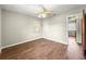 Empty bedroom featuring wood-look floors and window to let in natural light at 10739 Se 44Th Ter, Belleview, FL 34420