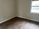Bedroom featuring wood floors, fresh paint, and a window allowing natural light at 10739 Se 44Th Ter, Belleview, FL 34420