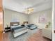 Staged bedroom with wood-look floors, ceiling fan, and two windows at 10739 Se 44Th Ter, Belleview, FL 34420