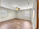 Bright bedroom with wood floors, ceiling fan, and natural light at 10739 Se 44Th Ter, Belleview, FL 34420
