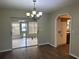 Bright dining room with sliding glass doors, chandelier, and access to the kitchen at 10739 Se 44Th Ter, Belleview, FL 34420