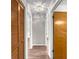 Hallway with wood-look floors featuring linen closet and open doorways to bedrooms at 10739 Se 44Th Ter, Belleview, FL 34420