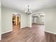 Open living area with wood-look floors and arched doorways to kitchen and entryway at 10739 Se 44Th Ter, Belleview, FL 34420