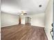 Spacious living room with wood-look floors, a ceiling fan, and neutral paint providing a versatile living space at 10739 Se 44Th Ter, Belleview, FL 34420