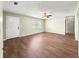 Bright and airy living room featuring wood-look flooring, ample space, and a ceiling fan providing an inviting atmosphere at 10739 Se 44Th Ter, Belleview, FL 34420