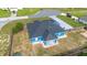 Aerial view of a well-maintained blue single-story home with a spacious backyard and driveway at 13115 Sw 49Th Ave, Ocala, FL 34473