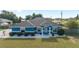 Overhead shot of a charming blue single-story home with a well-kept lawn and landscaped front yard at 13115 Sw 49Th Ave, Ocala, FL 34473