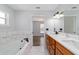 Stylish bathroom with double vanity, soaking tub, and wood-look cabinetry at 13115 Sw 49Th Ave, Ocala, FL 34473