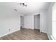 Bright bedroom featuring wood-look floors, closet, and neutral paint at 13115 Sw 49Th Ave, Ocala, FL 34473