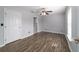 Spacious bedroom with wood-look flooring, ceiling fan, and ensuite bath at 13115 Sw 49Th Ave, Ocala, FL 34473