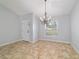 Bright dining room with a view, stylish chandelier, and neutral tile flooring at 13115 Sw 49Th Ave, Ocala, FL 34473