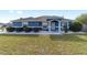 Charming blue single-story home with manicured landscaping, decorative rock, and an inviting entrance at 13115 Sw 49Th Ave, Ocala, FL 34473