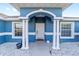 Inviting front porch with white columns and an arched entrance, enhancing curb appeal at 13115 Sw 49Th Ave, Ocala, FL 34473