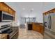 Well-lit kitchen features stainless steel appliances, granite countertops, and tile flooring at 13115 Sw 49Th Ave, Ocala, FL 34473