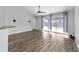 Spacious living room with modern ceiling fan and sliding glass doors to the outdoors at 13115 Sw 49Th Ave, Ocala, FL 34473