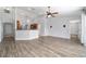 Open-concept living space with vaulted ceiling, modern fan and view of the kitchen at 13115 Sw 49Th Ave, Ocala, FL 34473