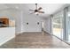 Living room with vaulted ceiling, modern fan and sliding glass door to the outside at 13115 Sw 49Th Ave, Ocala, FL 34473