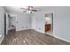 Open main bedroom with ensuite bathroom, modern flooring and ceiling fan at 13115 Sw 49Th Ave, Ocala, FL 34473
