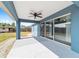Covered patio with a ceiling fan and access to the backyard through sliding glass doors at 13115 Sw 49Th Ave, Ocala, FL 34473
