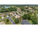 Overhead view of a residential area featuring homes, mature trees, and a nearby golf course at 15 Sunrise Dr, Ocala, FL 34472