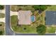 Overhead view of a private backyard with a pool, lush landscaping, and a well-maintained lawn at 15 Sunrise Dr, Ocala, FL 34472