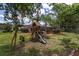 Backyard featuring a playset and screened-in pool area for outdoor enjoyment and relaxation at 15 Sunrise Dr, Ocala, FL 34472