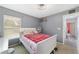 Comfortable bedroom features a gray wall, white bed, and a ceiling fan for added comfort at 15 Sunrise Dr, Ocala, FL 34472