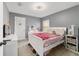 Cozy bedroom with gray walls, a white bed, and ample natural light from the window at 15 Sunrise Dr, Ocala, FL 34472
