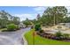 View of the community entrance with manicured landscaping and detailed signage at 15 Sunrise Dr, Ocala, FL 34472