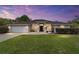 Charming single-story home with well-manicured lawn and inviting front entrance at dusk at 15 Sunrise Dr, Ocala, FL 34472