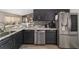 Kitchen featuring stainless steel appliances, dark cabinets and a view to the breakfast nook at 15 Sunrise Dr, Ocala, FL 34472