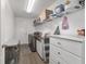 Well-organized laundry room with white cabinets, modern appliances, and ample storage space at 15 Sunrise Dr, Ocala, FL 34472