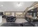 Open concept living room with hardwood floors, neutral paint, and a large window offering backyard views at 15 Sunrise Dr, Ocala, FL 34472