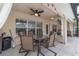 Covered patio features a ceiling fan and ample space for outdoor dining or seating with access to the backyard at 15 Sunrise Dr, Ocala, FL 34472