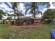 Private backyard showcasing a screened pool, lush landscaping, and outdoor recreational space at 15 Sunrise Dr, Ocala, FL 34472