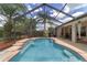 Backyard features a pool, covered patio, and privacy landscaping at 15 Sunrise Dr, Ocala, FL 34472