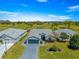 Aerial view of well-maintained home, showing a paved driveway, mature landscaping, and the roof at 15825 Sw 11Th Court Rd, Ocala, FL 34473