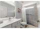 Light and airy bathroom with a white single sink vanity, and a tile walk-in shower with a built-in bench at 15825 Sw 11Th Court Rd, Ocala, FL 34473