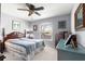 Bedroom featuring a queen size bed, window with blinds, ceiling fan, and wood dresser with mirror at 15825 Sw 11Th Court Rd, Ocala, FL 34473