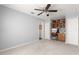 Open bedroom featuring neutral carpet and light gray walls with a ceiling fan and closet and office nook at 15825 Sw 11Th Court Rd, Ocala, FL 34473