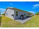 Exterior view of home, highlighting the back patio, gray siding, well-maintained lawn, and golf course views at 15825 Sw 11Th Court Rd, Ocala, FL 34473