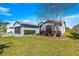 Beautifully landscaped home featuring a lush lawn, manicured shrubs, and a side-entry garage enhancing curb appeal at 15825 Sw 11Th Court Rd, Ocala, FL 34473