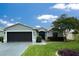 Charming single-story home featuring a well-manicured lawn, mature landscaping, and a two-car garage at 15825 Sw 11Th Court Rd, Ocala, FL 34473