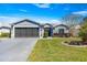 Charming single-story home with a well-manicured lawn, brick driveway, and two-car garage in a peaceful neighborhood at 15825 Sw 11Th Court Rd, Ocala, FL 34473