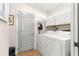 Functional laundry room with a washer, dryer, storage cabinets, and ample space for sorting and folding laundry at 15825 Sw 11Th Court Rd, Ocala, FL 34473