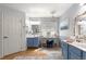 Bright and airy main bathroom with dual vanities, designer mirrors and lighting, and a decorative chandelier at 15825 Sw 11Th Court Rd, Ocala, FL 34473